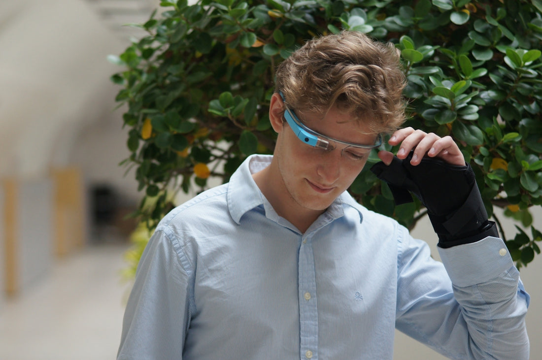 man in blue dress shirt wearing blue framed eyeglasses