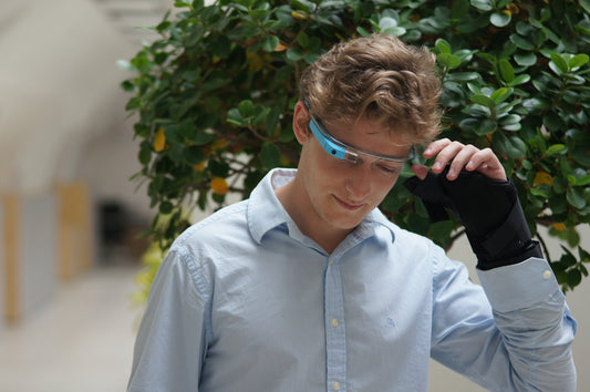 man in blue dress shirt wearing blue framed eyeglasses